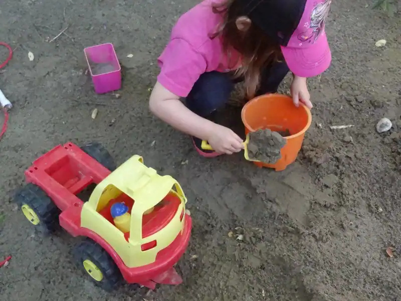 Gallery 2 Child playing in sandbox with toy truck and sand bucket at Diana Daycare, Newmarket.