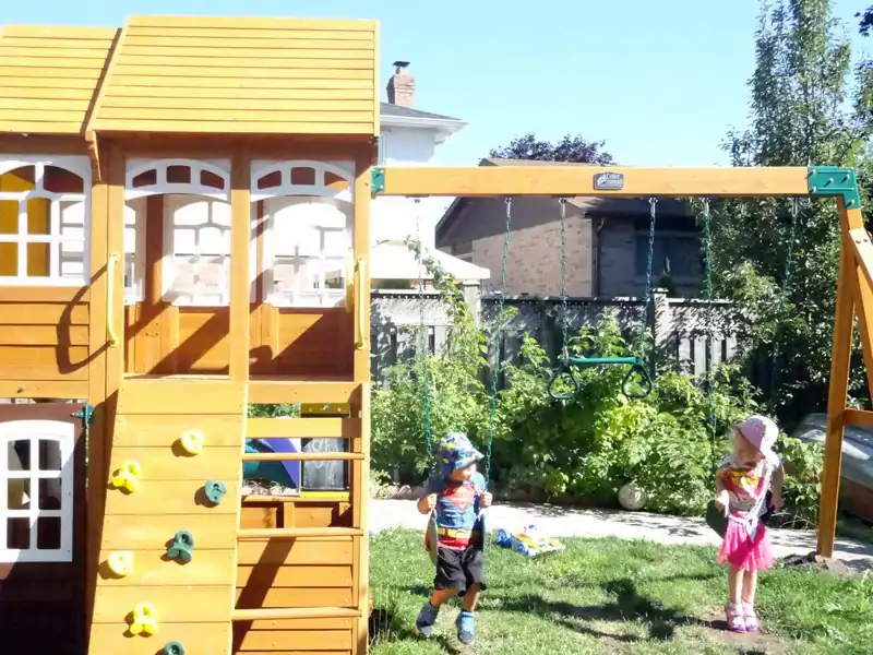 Gallery 6 Bright, safe play area with swings and climbing structures for young children.